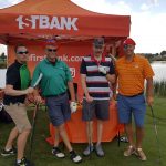 FirstBank employees in costume standing near their booth outdoors