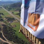 FirstBank tarpaulin hanging on a floating hot air balloon
