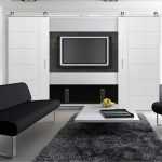 White Door With Black Sofa And White Center Table