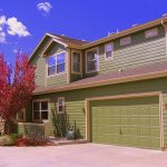 front exterior of a home and garage with light green paint