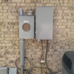 Electric box on the exterior wall of a home, with wires securely connected for electrical service