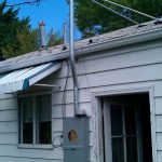 Electrical box mounted with a rigid riser offset around the gutter