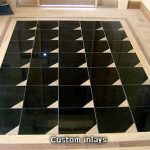 custom flooring with black and white tiles arranged in a geometric pattern