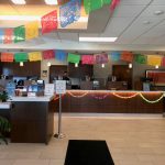FirstBank bank counter decorated with garlands and hanging pennant banners