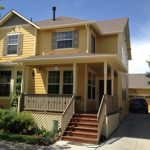 small yellow house with front steps