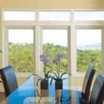 dining area surrounded by windows overlooking the mountains