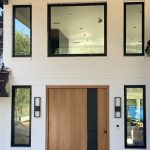 large glass windows surrounding entrance door of home