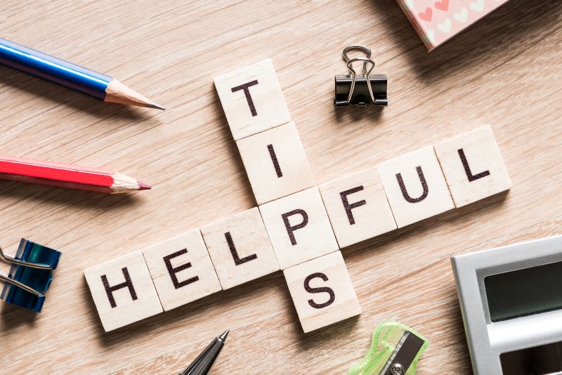 connected wooden tiles with letters spelling helpful tips