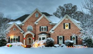 front exterior of a house surrounded with snow in wintertime