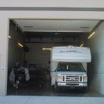 A garage condo with white van inside