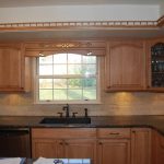 The kitchen has a clean and bright aesthetic with white upper and lower cabinets.