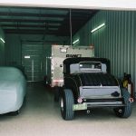 1930 Ford pickup truck and another vehicle covered