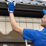 worker fixing part of a house roof