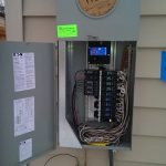 Exposed service panel with visible wires and circuit breakers