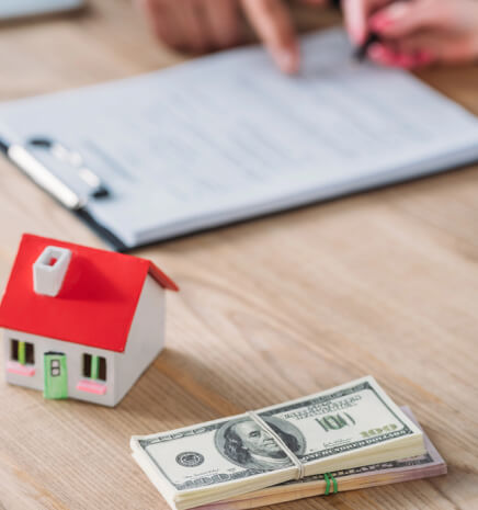 img - businessman-pointing-signature-place-loan-agreement-house-model