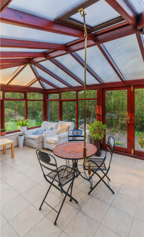 conservatory tables chairs plants room in house next to garden