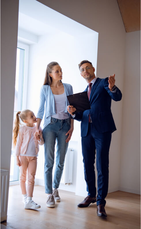 img - handsome-broker-showing-room-while-standing-attractive-woman-kid