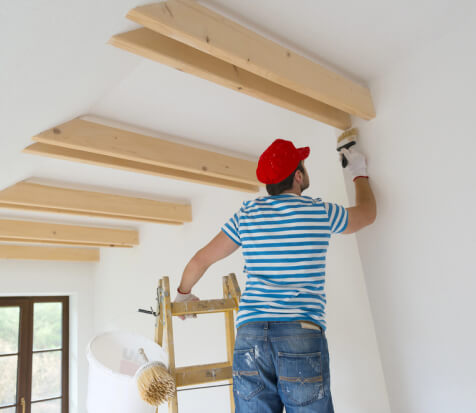 Interior Painting worker painting the wall white