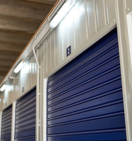 img - numbered-storage-items-blue-metal-roller-doors-bright-lamps-modern