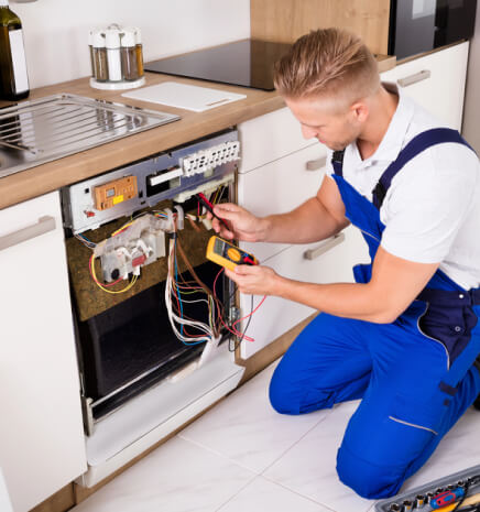 repairman fixing dishwasher