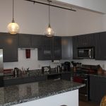 kitchen with hanging lights and newly painted walls