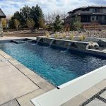 Modern backyard with a small rectangular pool featuring three waterfalls