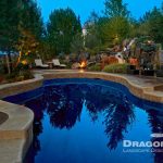 freeform shape pool with lounge chairs and stone poolscape with mini waterfall