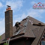 A person performing roof repair on a residential property