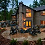 outdoor firepit area of a home surrounded by tall trees