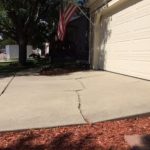 concrete with crack in front of garage door