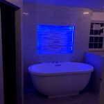 A residential bathroom with a freestanding bathtub