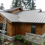 newly installed roofing of a small brick house