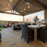 large covered deck with dining table and chairs