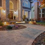 concrete walkway to the entrance door of a large house