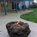 A lava rock fire pit outside