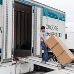 man with stacked three boxes