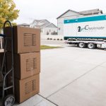 Checkmate Moving and Storage truck with stacked three boxes