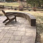 A patio area featuring a curved, built-in bench
