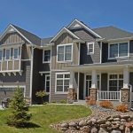 modern suburban house made with stone and shingle siding