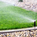 water sprinkler spraying on grass