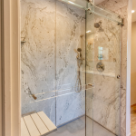 walk-in shower with glass door inside