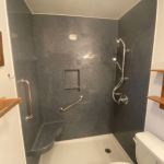 open shower beside the toilet bowl